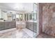 Luxurious primary bathroom with marble accents, double vanities, soaking tub, and a glass-enclosed shower at 3901 S Dexter St, Cherry Hills Village, CO 80113