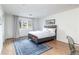 Comfortable bedroom features hardwood floors, a large window, and minimalist decor at 3901 S Dexter St, Cherry Hills Village, CO 80113