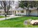 Attractive single story exterior with green lawn and sidewalk leading to the front door at 3901 S Dexter St, Cherry Hills Village, CO 80113