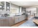 Well-lit kitchen boasts stainless appliances, gray cabinets, subway tile backsplash, and a large window at 3901 S Dexter St, Cherry Hills Village, CO 80113