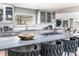 Bright kitchen with stainless steel appliances, light gray cabinets, subway tile backsplash, and island seating at 3901 S Dexter St, Cherry Hills Village, CO 80113