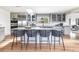 Contemporary kitchen with island seating, stainless appliances, light gray cabinetry, and skylight at 3901 S Dexter St, Cherry Hills Village, CO 80113
