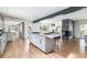 Open kitchen and dining area featuring a large island, modern fireplace, and hardwood floors at 3901 S Dexter St, Cherry Hills Village, CO 80113