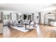 Spacious living room with hardwood floors, large sectional sofa, area rug, and lots of natural light at 3901 S Dexter St, Cherry Hills Village, CO 80113