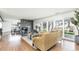 Open living room featuring a stone fireplace, wood floors, and sliding glass doors at 3901 S Dexter St, Cherry Hills Village, CO 80113