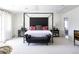 Stylish primary bedroom features a four-poster bed, bench, and neutral decor with pops of color at 3901 S Dexter St, Cherry Hills Village, CO 80113