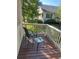 Private balcony with wood floors and a view of the exterior landscaping, chair and small table at 1311 S Kingston St, Aurora, CO 80012