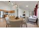 Open-concept living area with a cozy fireplace, adjacent to a modern kitchen at 1311 S Kingston St, Aurora, CO 80012