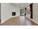 Open-concept living area featuring hardwood floors and a corner fireplace at 1311 S Kingston St, Aurora, CO 80012