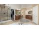 Luxurious bathroom featuring a soaking tub, a separate shower, a walk in closet, and dual vanities at 7852 Solstice Way, Castle Rock, CO 80108