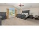 Spacious main bedroom features vaulted ceilings, a ceiling fan, neutral carpeting and large windows at 7852 Solstice Way, Castle Rock, CO 80108
