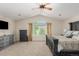 Spacious main bedroom features vaulted ceilings, a ceiling fan, neutral carpeting and large windows at 7852 Solstice Way, Castle Rock, CO 80108