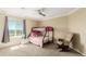 Bright bedroom with a bunk bed near a window, featuring a comfortable rocking chair and ample natural light at 7852 Solstice Way, Castle Rock, CO 80108