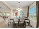 Inviting dining room featuring a modern chandelier, a large window, and stylish decor, perfect for entertaining at 7852 Solstice Way, Castle Rock, CO 80108