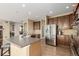 Spacious kitchen featuring stainless steel appliances, a large island, and plenty of cabinet space, designed for modern living at 7852 Solstice Way, Castle Rock, CO 80108