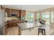 Open kitchen boasts stainless appliances, wood cabinets, granite countertops and island seating at 7852 Solstice Way, Castle Rock, CO 80108
