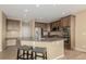 Well-equipped kitchen features stainless steel appliances, a breakfast bar, and wooden cabinets, ideal for cooking at 7852 Solstice Way, Castle Rock, CO 80108