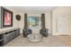 Cozy living room features neutral walls, a large window, two armchairs, and a unique round coffee table at 7852 Solstice Way, Castle Rock, CO 80108