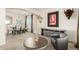 Spacious living area flows into dining space with neutral tones, large windows, stylish decor, and comfortable seating at 7852 Solstice Way, Castle Rock, CO 80108