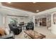 Open-concept living room with comfortable seating, game table, and view into the kitchenette at 7852 Solstice Way, Castle Rock, CO 80108