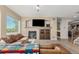 Bright living room features a fireplace, mantle, and comfortable seating with views at 7852 Solstice Way, Castle Rock, CO 80108