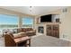Bright living room with fireplace, mantle, and a large sectional couch with beautiful views at 7852 Solstice Way, Castle Rock, CO 80108