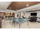 Spacious recreation area with a ping pong table, bar seating, and comfortable lounge at 7852 Solstice Way, Castle Rock, CO 80108