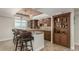 Wet bar with seating, shelving, and a view of the window and scenic view at 7852 Solstice Way, Castle Rock, CO 80108