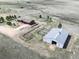 Aerial shot showcases property with a barn, horse pens, large lot, and a beautiful home at 12973 Mesa View Rd, Larkspur, CO 80118