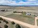 Aerial view of house, barn and expansive land with dirt roads and beautiful mountain views at 12973 Mesa View Rd, Larkspur, CO 80118