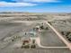 Aerial view of property featuring home, barn, pens, and expansive land with mountain views under a blue sky at 12973 Mesa View Rd, Larkspur, CO 80118