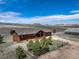 Beautiful aerial view of home, landscaping, barn, fencing, and mountain views at 12973 Mesa View Rd, Larkspur, CO 80118