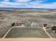 Expansive aerial view of a ranch featuring the house, barn, and land surrounded by picturesque mountains at 12973 Mesa View Rd, Larkspur, CO 80118