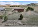 Scenic aerial view of home, barn, horse pens, and landscaped yard in a beautiful country setting at 12973 Mesa View Rd, Larkspur, CO 80118