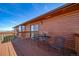 Lovely, covered back deck complete with seating for outdoor dining and relaxation at 12973 Mesa View Rd, Larkspur, CO 80118