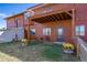 Backyard featuring a deck, flowers and seating at 12973 Mesa View Rd, Larkspur, CO 80118