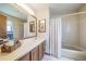 Classic bathroom featuring a vanity with sink, ample counter space, and a tub with shower at 12973 Mesa View Rd, Larkspur, CO 80118