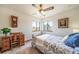 Bedroom with a desk, chair, neutral colored walls, and soft natural light from the surrounding windows at 12973 Mesa View Rd, Larkspur, CO 80118