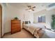 Cozy bedroom with natural light, ceiling fan, and furnishings at 12973 Mesa View Rd, Larkspur, CO 80118