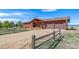 Rustic ranch-style home featuring a wooden exterior, well-maintained front yard, and convenient driveway at 12973 Mesa View Rd, Larkspur, CO 80118