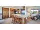 A practical kitchen with breakfast bar, wood cabinets and an adjacent view to the outside at 12973 Mesa View Rd, Larkspur, CO 80118