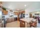 A functional kitchen featuring a stainless steel refrigerator, wood cabinets, a breakfast bar and outside view at 12973 Mesa View Rd, Larkspur, CO 80118
