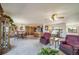Open-concept living room and dining area featuring neutral tones and plenty of natural light from surrounding windows at 12973 Mesa View Rd, Larkspur, CO 80118