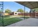 A tranquil backyard featuring a covered patio, shed, and fenced perimeter, perfect for outdoor enjoyment at 3529 N Garfield St, Denver, CO 80205