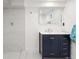 Updated bathroom features a navy vanity, walk-in shower, and sleek fixtures at 3529 N Garfield St, Denver, CO 80205
