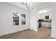 Open dining area with updated lighting and open concept to modern kitchen at 3529 N Garfield St, Denver, CO 80205