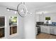 Bright kitchen featuring stainless steel appliances and an eye-catching modern light fixture at 3529 N Garfield St, Denver, CO 80205