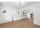Bright, open-concept living space with wood floors, modern lighting, and arched doorway at 3529 N Garfield St, Denver, CO 80205