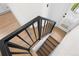 Staircase with wooden steps and a black metal railing at 3529 N Garfield St, Denver, CO 80205