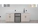 Basement wet bar with white cabinets, quartz countertops and a beverage fridge at 3529 N Garfield St, Denver, CO 80205